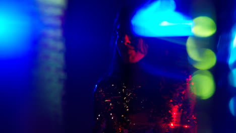 Close-Up-Of-Woman-Having-Fun-Dancing-In-Disco-Nightclub-Or-Bar-Shot-With-Tinsel-in-Foreground-3